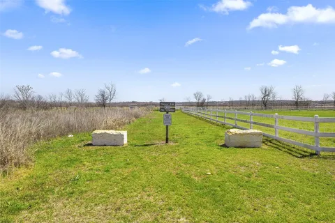 a view of a lake with a bench in the background