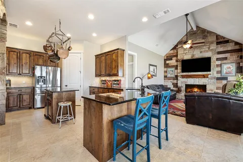 a living room with lots of furniture and kitchen view