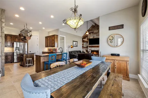 a living room with lots of furniture and kitchen view