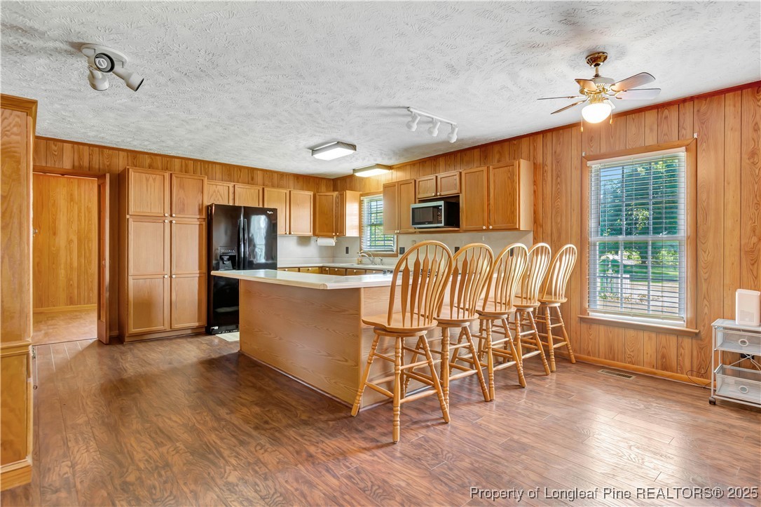 725 Henry Hammond Road Lumberton, NC 28360 - Photo 11 of 42 a kitchen with stainless steel appliances a microwave a stove a refrigerator cabinets and wooden floor