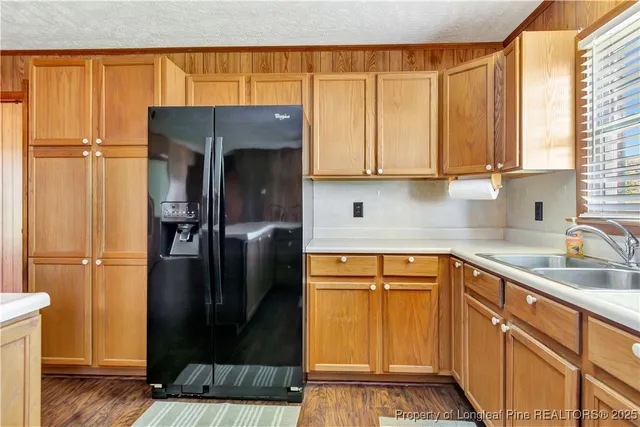 a kitchen with a refrigerator and cabinets