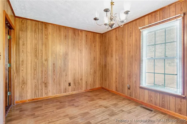 a view of a room with a window and wooden floor