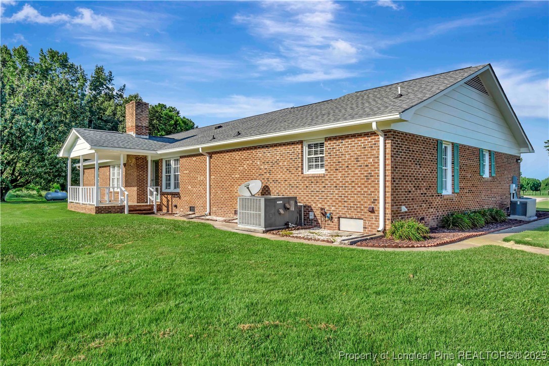 725 Henry Hammond Road Lumberton, NC 28360 - Photo 37 of 42 a view of a house with backyard and porch