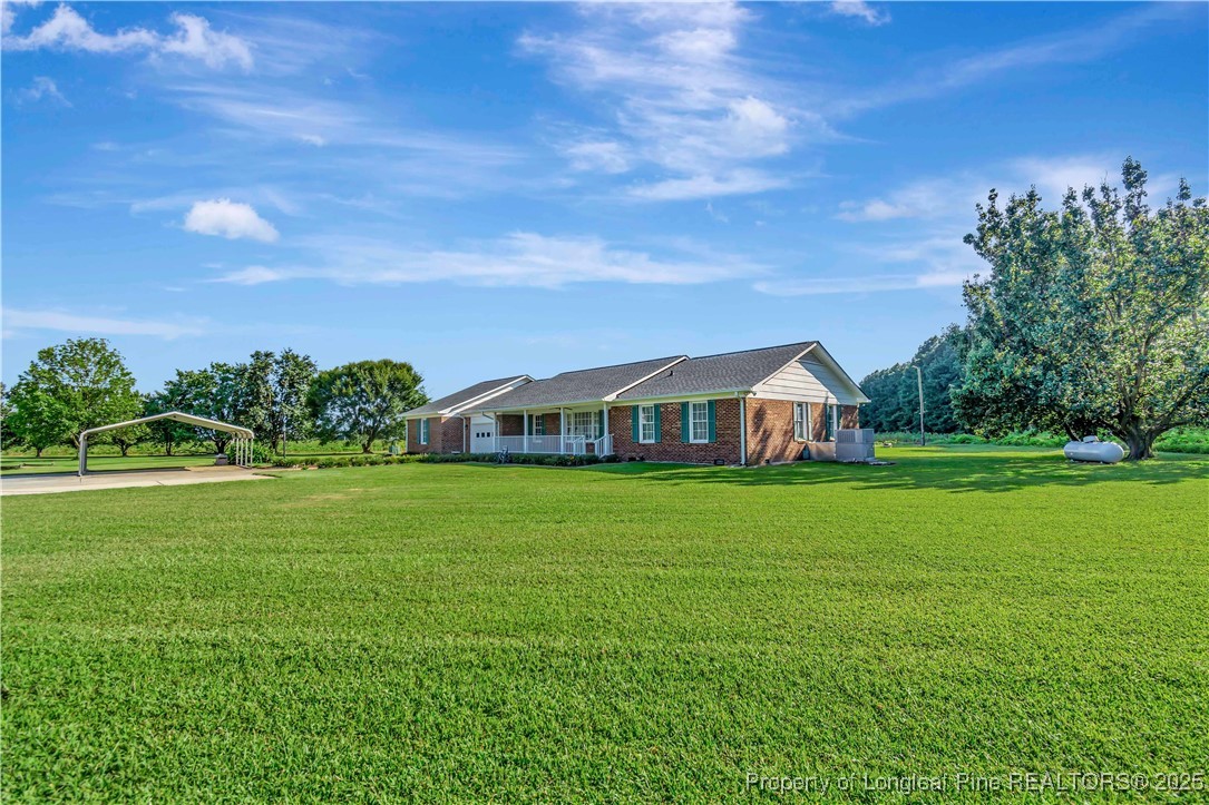 725 Henry Hammond Road Lumberton, NC 28360 - Photo 4 of 42 a front view of a house with garden