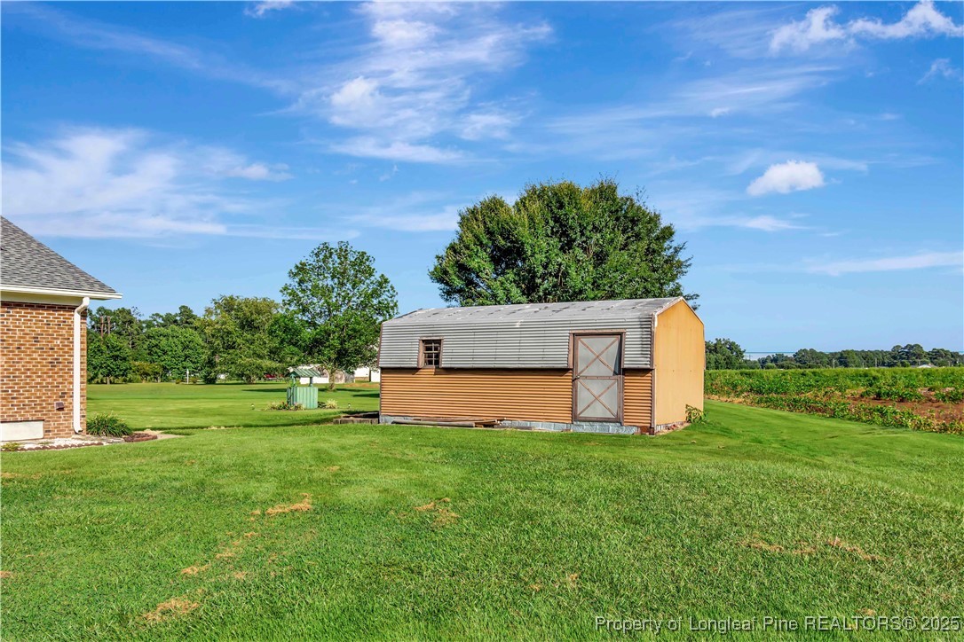 725 Henry Hammond Road Lumberton, NC 28360 - Photo 41 of 42 a white house with a big yard and big trees with a big yard