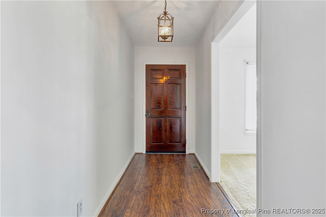 725 Henry Hammond Road Lumberton, NC 28360 - Photo 7 of 42 a view of a hallway with wooden floor