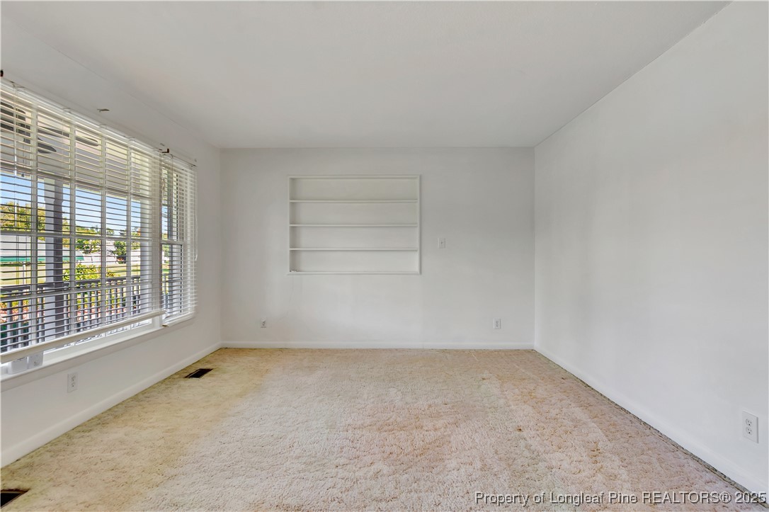 725 Henry Hammond Road Lumberton, NC 28360 - Photo 8 of 42 an empty room with a empty space and windows