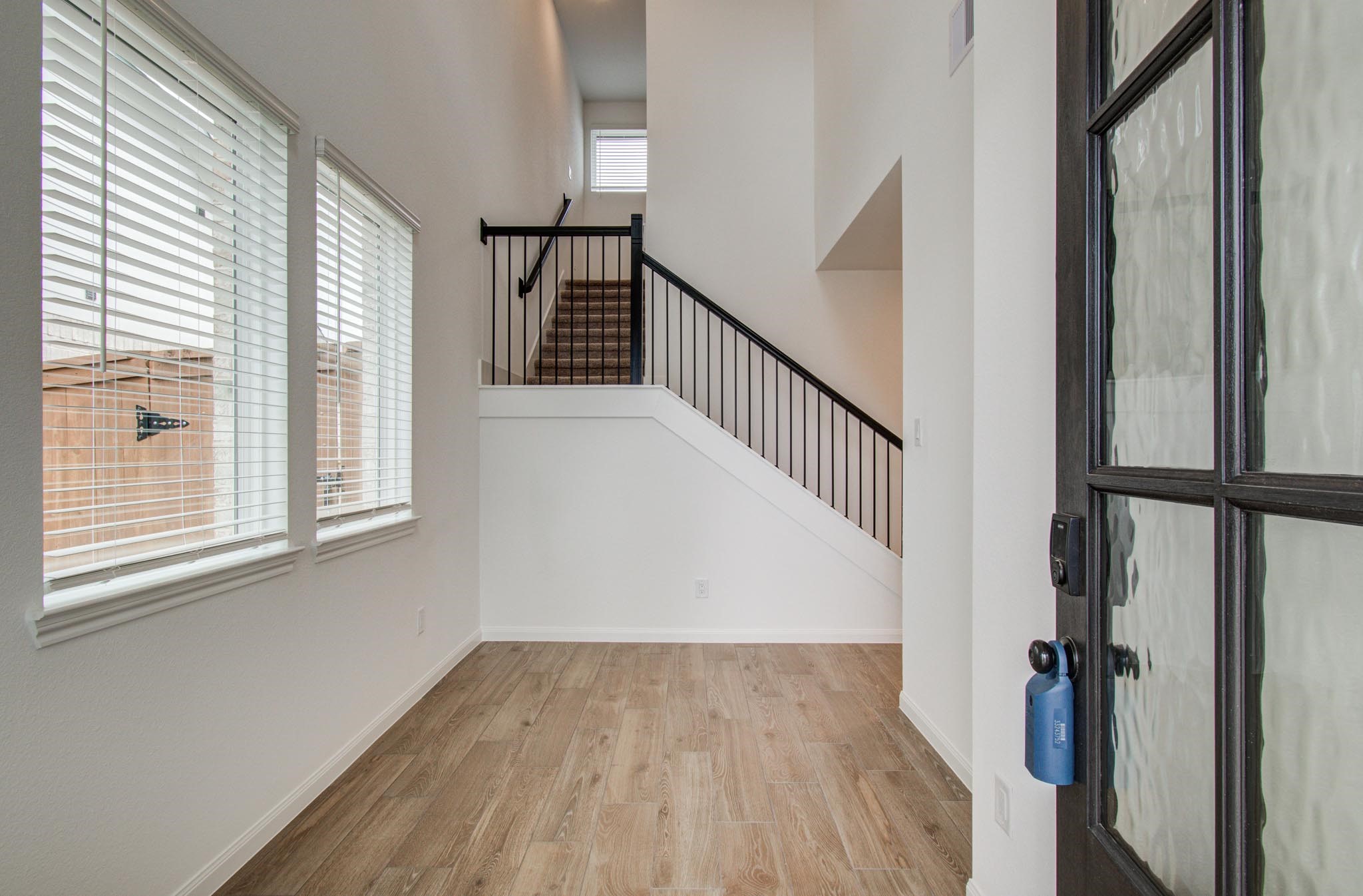7231 Yarrow Blossom Court Katy, TX 77493 - Photo 11 of 49 a view of a hallway with wooden floor and staircase