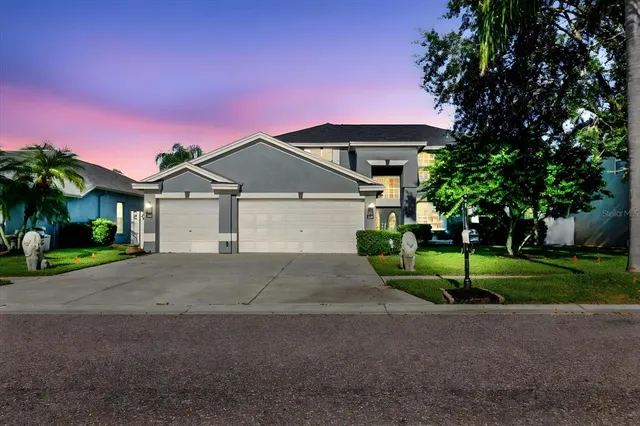 a front view of a house with a yard and garage