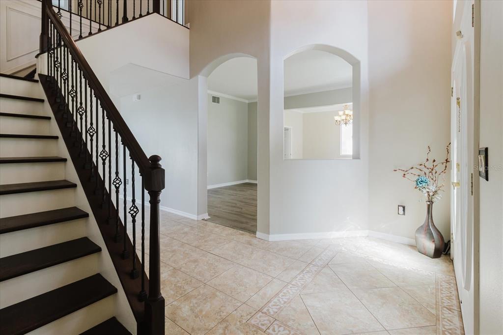1725 Pink Guara Court Trinity, FL 34655 - Photo 11 of 100 a view of a hallway with wooden floor and staircase