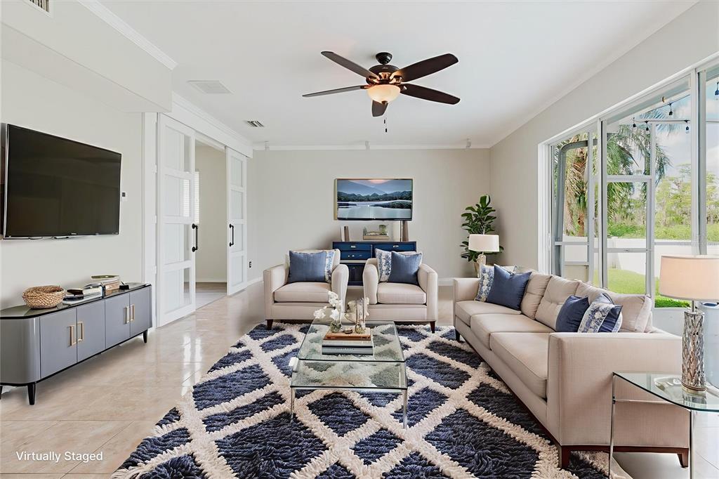 1725 Pink Guara Court Trinity, FL 34655 - Photo 12 of 100 a living room with furniture and a flat screen tv