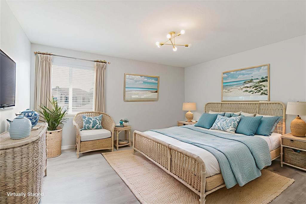 1725 Pink Guara Court Trinity, FL 34655 - Photo 16 of 100 a bedroom with a large bed and a couch