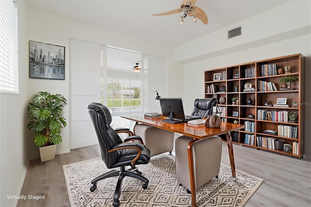 1725 Pink Guara Court Trinity, FL 34655 - Photo 17 of 100 a view of a workspace with furniture and a bookshelf