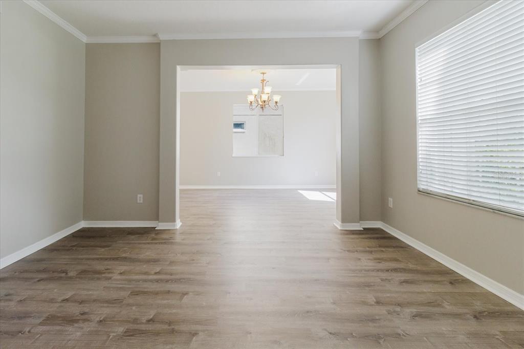 1725 Pink Guara Court Trinity, FL 34655 - Photo 18 of 100 wooden floor in an empty room with a window