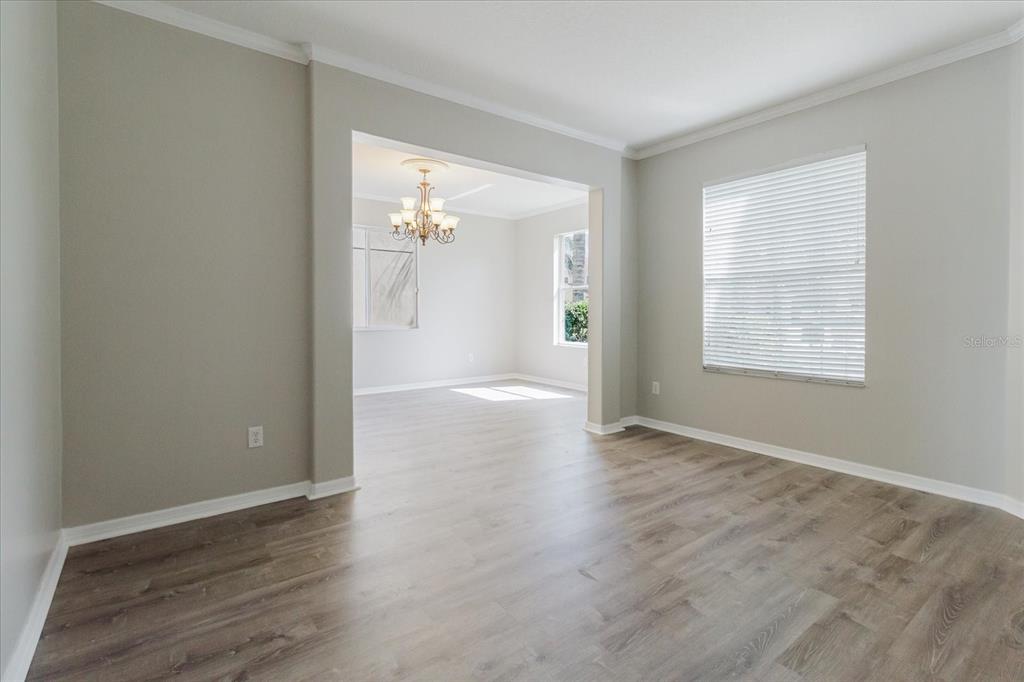 1725 Pink Guara Court Trinity, FL 34655 - Photo 19 of 100 an empty room with wooden floor and windows