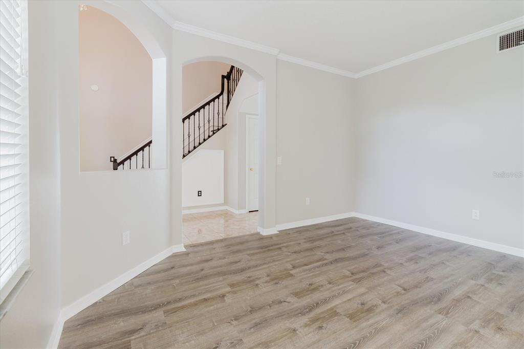 1725 Pink Guara Court Trinity, FL 34655 - Photo 20 of 100 a view of an empty room with wooden floor and entryway