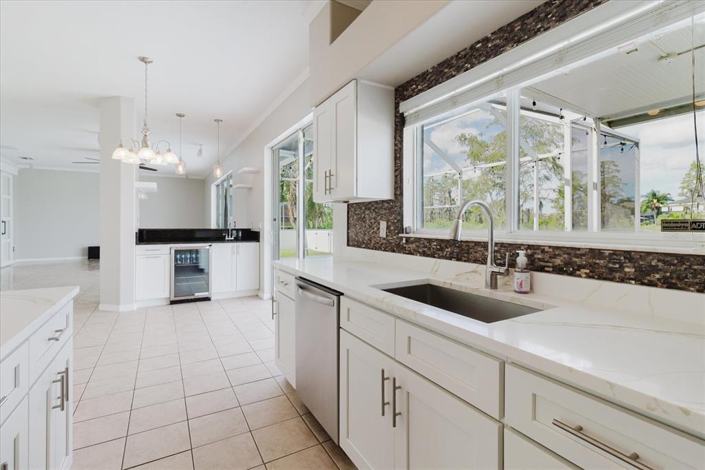 1725 Pink Guara Court Trinity, FL 34655 - Photo 39 of 100 a large white kitchen with a large window and stainless steel appliances
