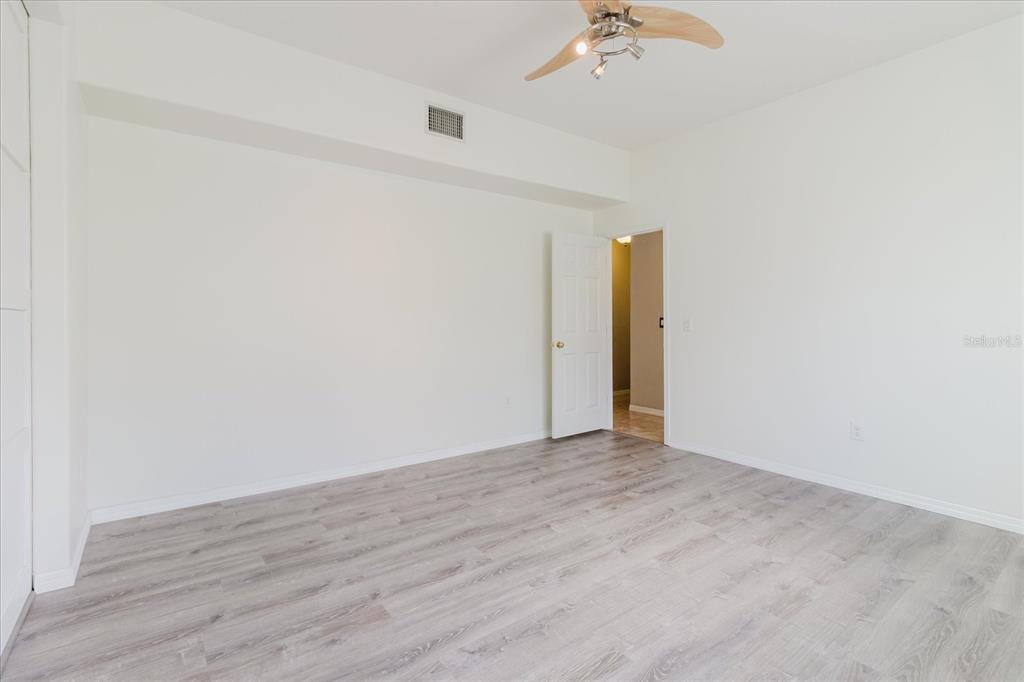 1725 Pink Guara Court Trinity, FL 34655 - Photo 45 of 100 an empty room with wooden floor and fan