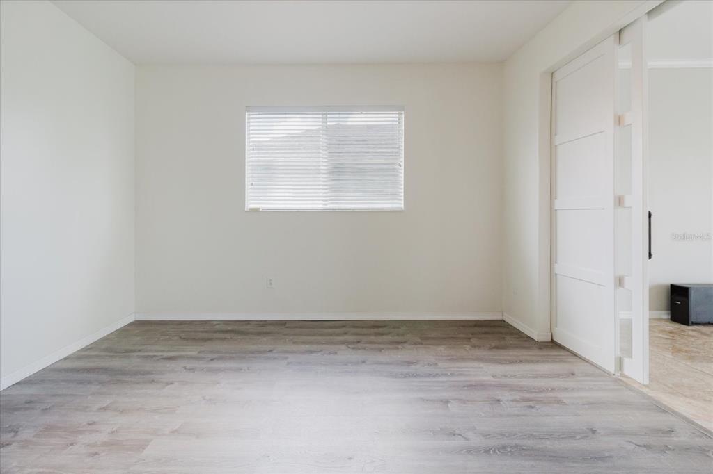 1725 Pink Guara Court Trinity, FL 34655 - Photo 46 of 100 an empty room with wooden floor and windows