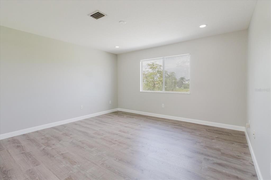 1725 Pink Guara Court Trinity, FL 34655 - Photo 51 of 100 an empty room with wooden floor and windows