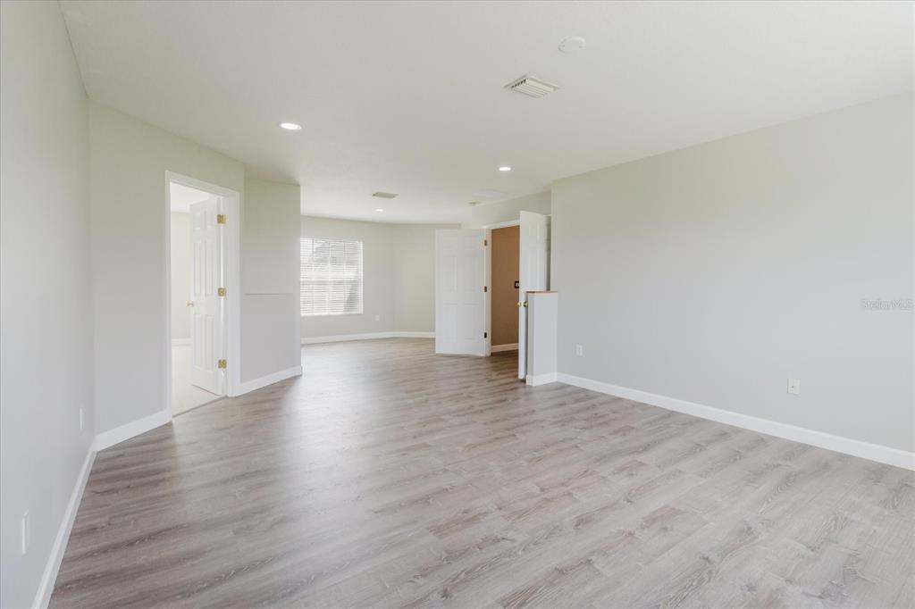 1725 Pink Guara Court Trinity, FL 34655 - Photo 54 of 100 a view of an empty room with wooden floor and window
