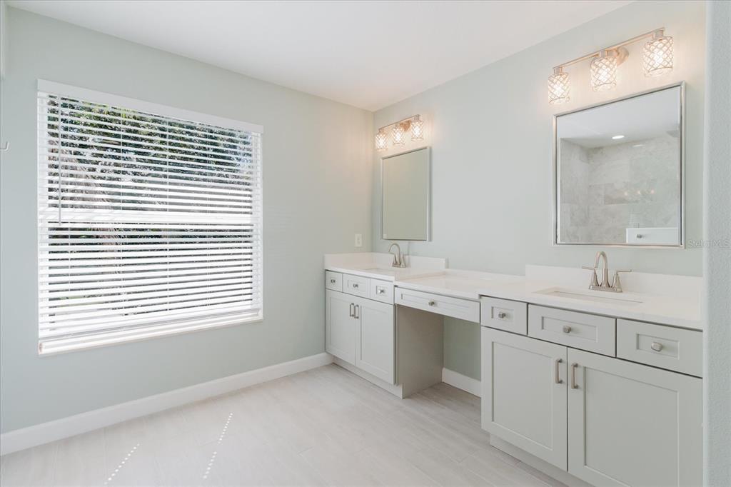 1725 Pink Guara Court Trinity, FL 34655 - Photo 58 of 100 a bathroom with a sink double vanity and a mirror