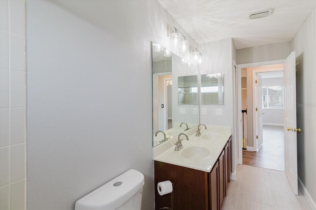 1725 Pink Guara Court Trinity, FL 34655 - Photo 72 of 100 a bathroom with a sink a toilet and shower