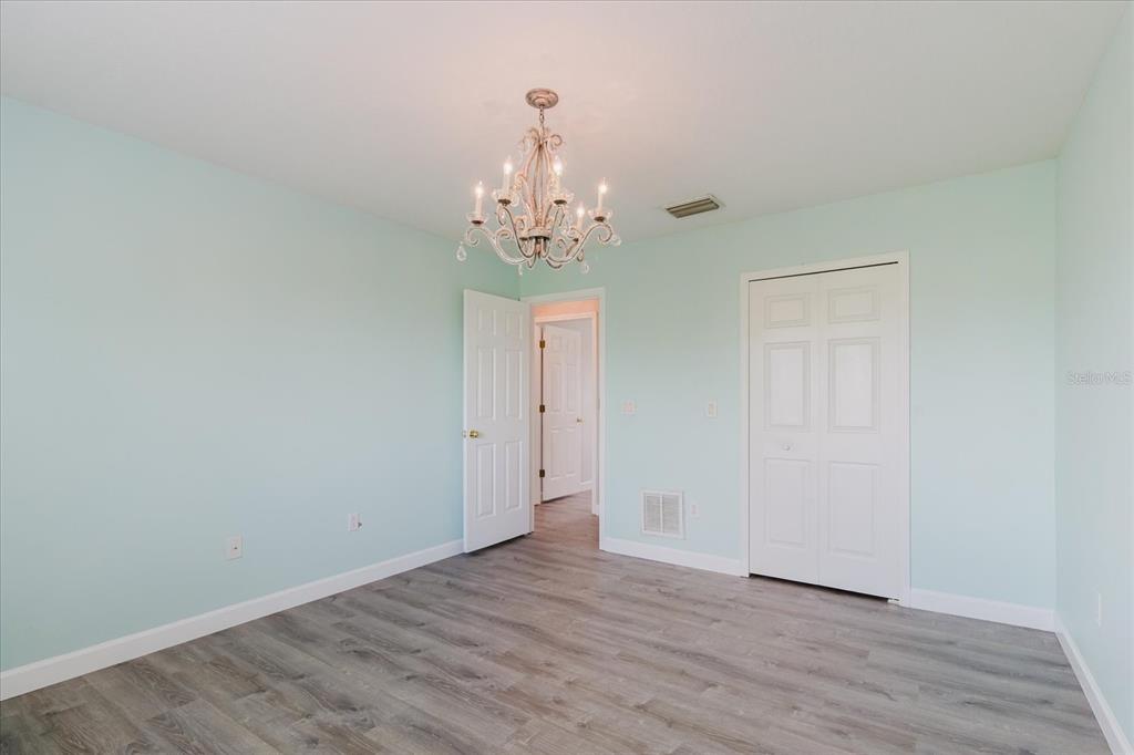 1725 Pink Guara Court Trinity, FL 34655 - Photo 80 of 100 a view of an empty room with wooden floor and windows