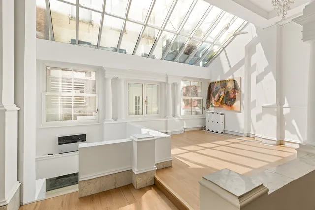 a spacious bedroom with a bed and a large window