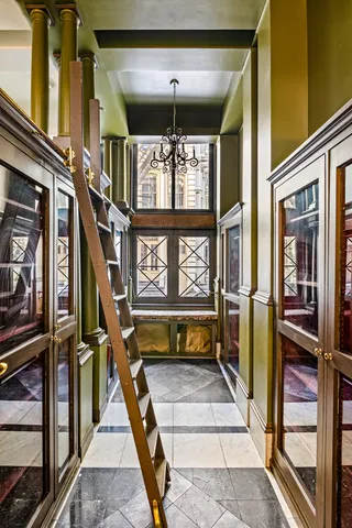 a room with lots of windows and furniture