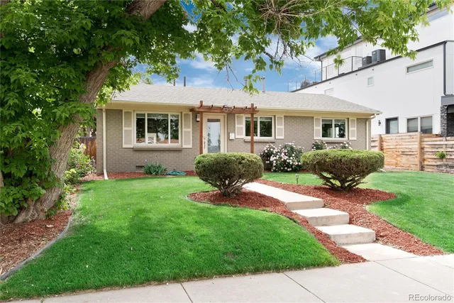 a view of a house with backyard sitting area and garden