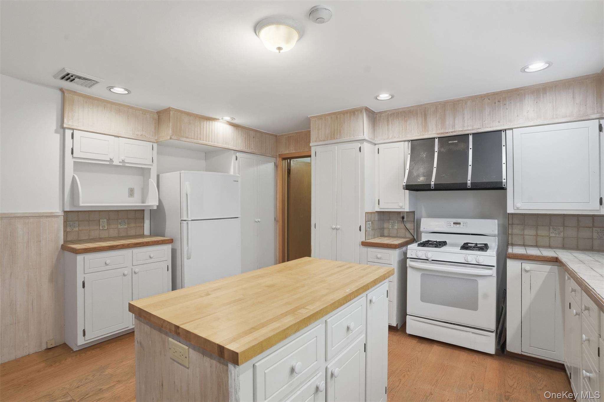435 Samsonville Road Kerhonkson, NY 12446 - Photo 12 of 37 a kitchen with a sink a stove a refrigerator and white cabinets