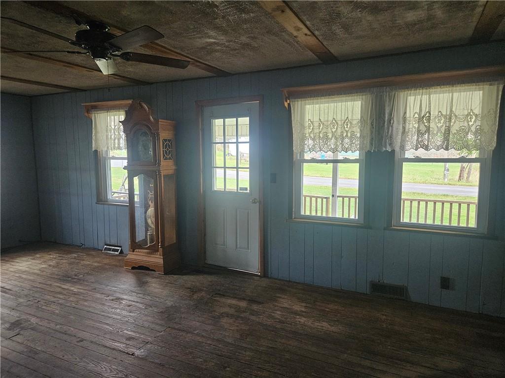 214 Bestwick Road Mercer, PA 16137 - Photo 2 of 19 an empty room with wooden floor and windows