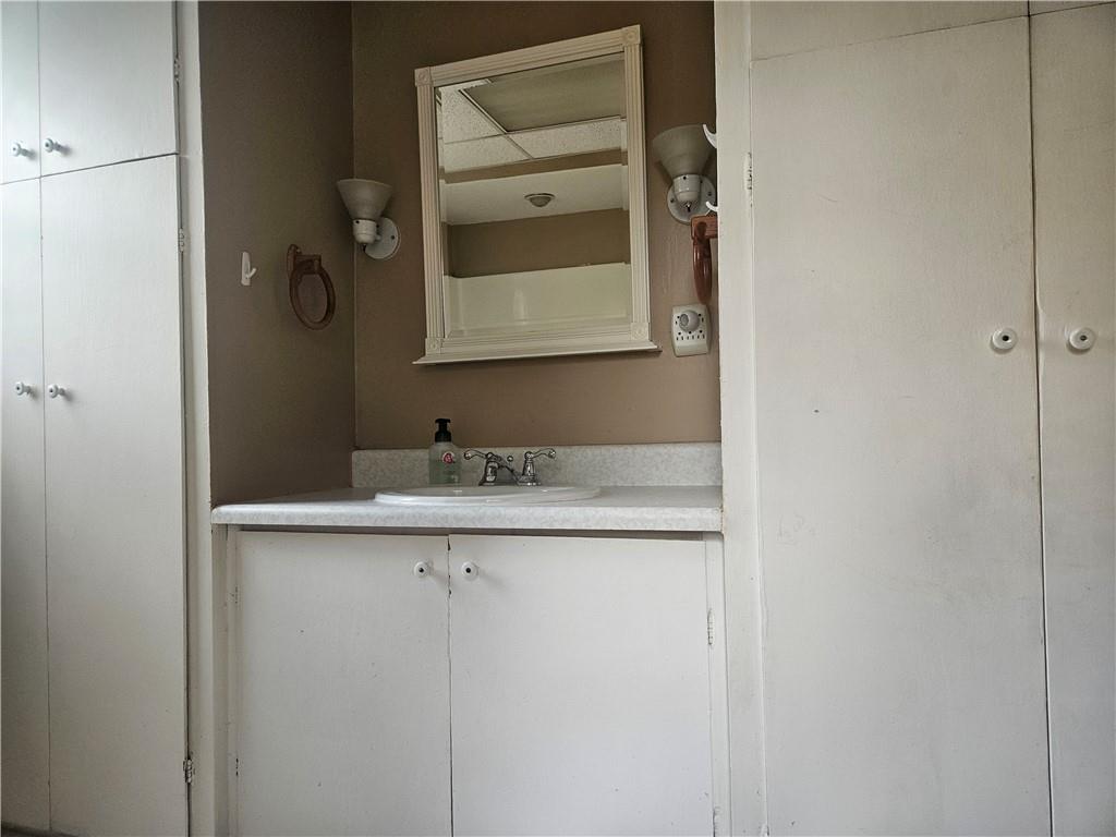 214 Bestwick Road Mercer, PA 16137 - Photo 8 of 19 a bathroom with a granite countertop sink and a mirror