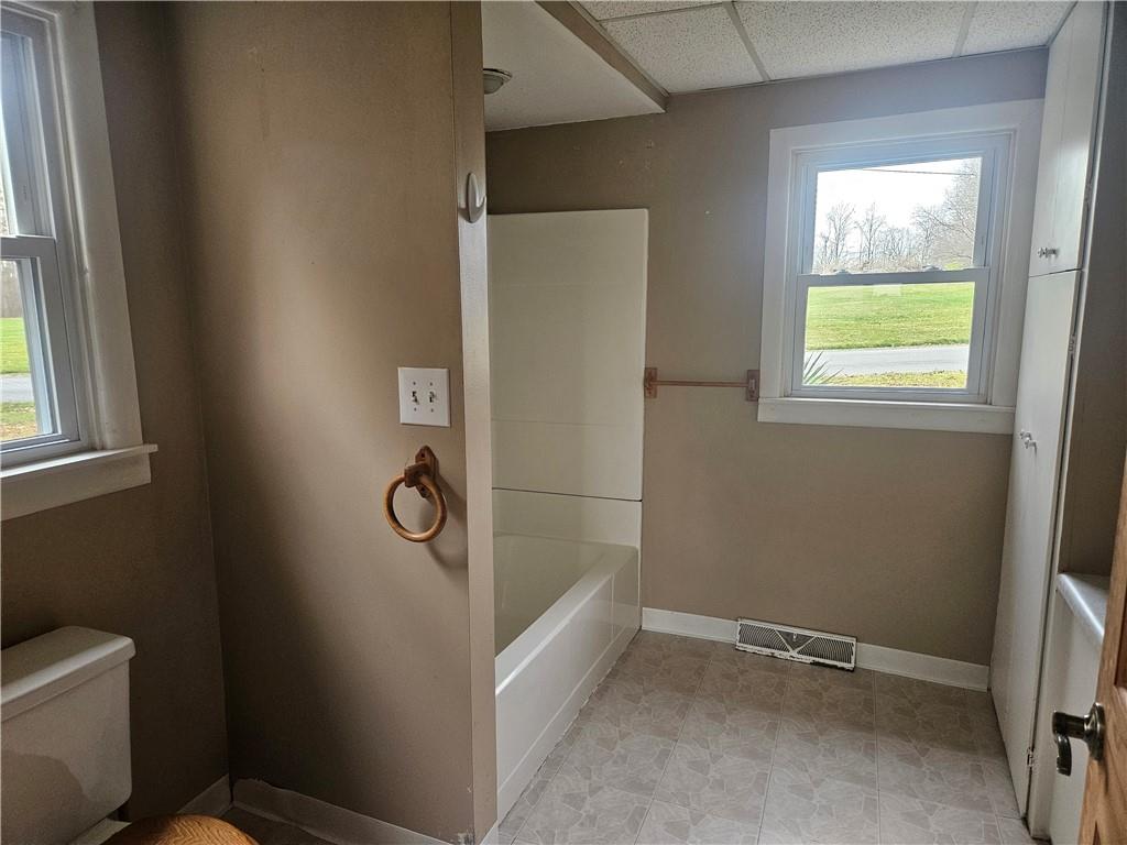 214 Bestwick Road Mercer, PA 16137 - Photo 9 of 19 a bathroom with a granite countertop toilet and a window