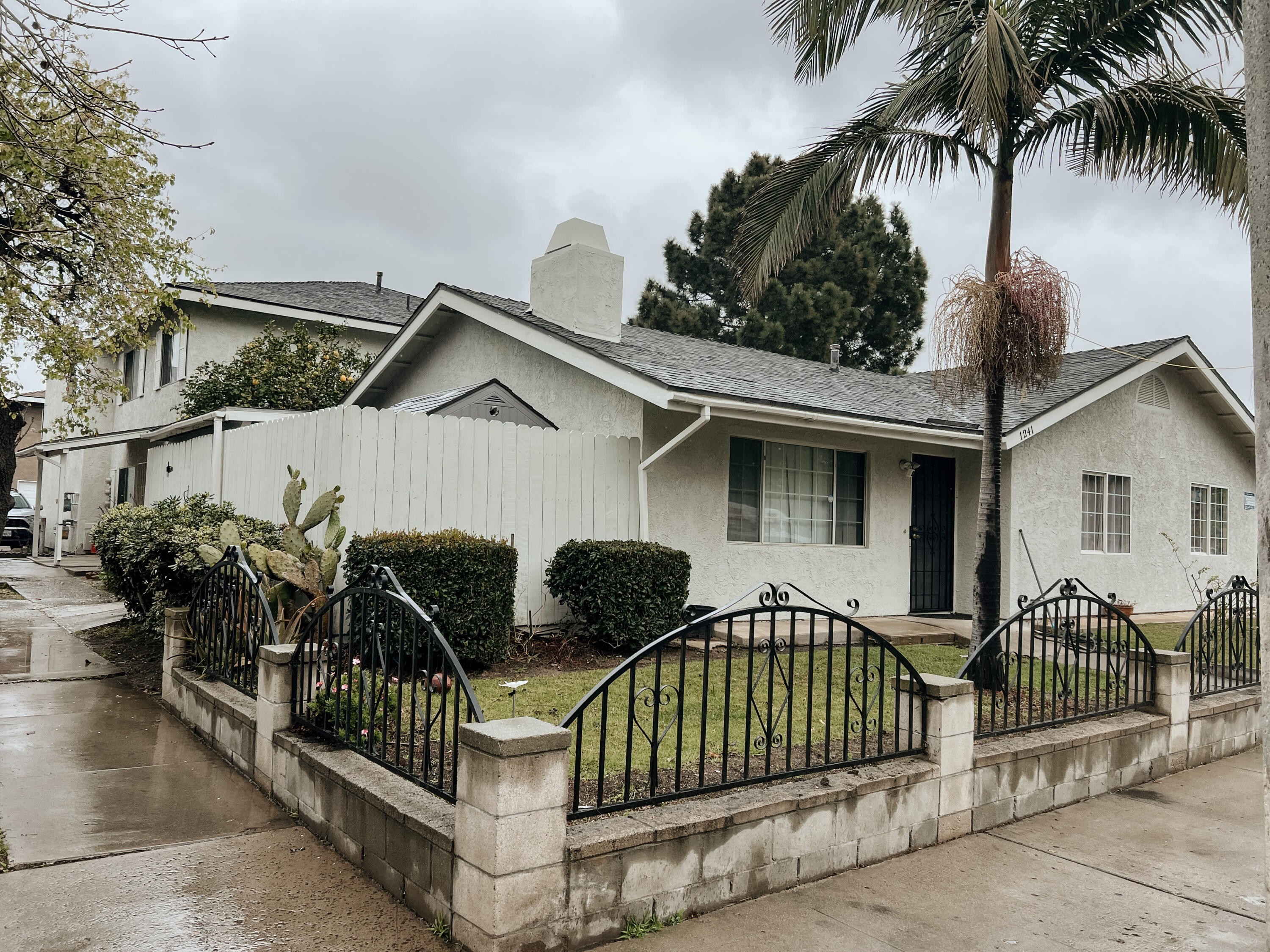 1241 West 7th Street, Unit 1 Oxnard, CA 93030 - Photo 2 of 8 a view of a house with a wooden deck and a yard