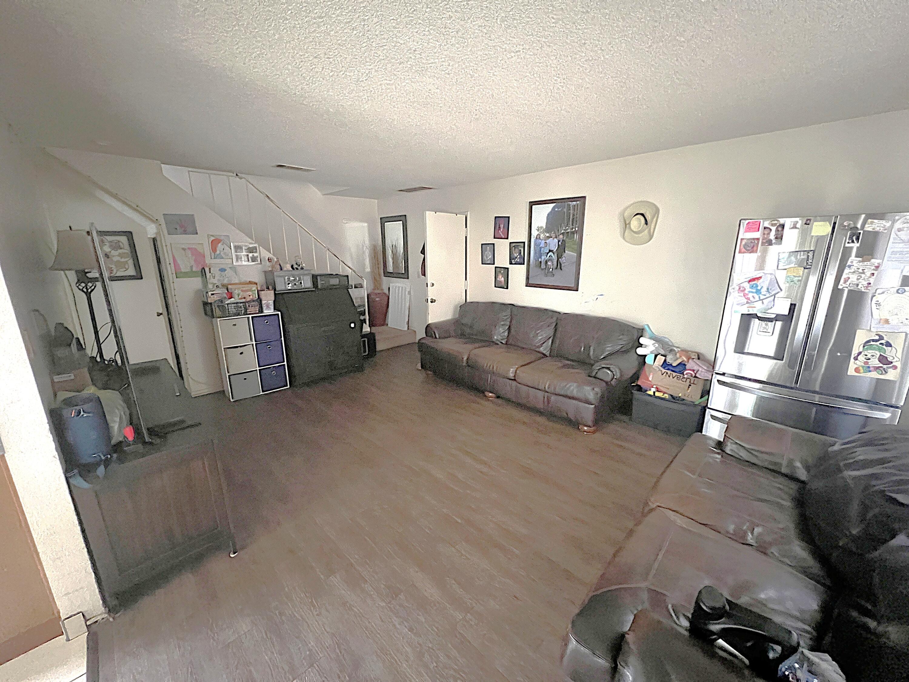 1241 West 7th Street, Unit 1 Oxnard, CA 93030 - Photo 5 of 8 a living room with furniture and a flat screen tv