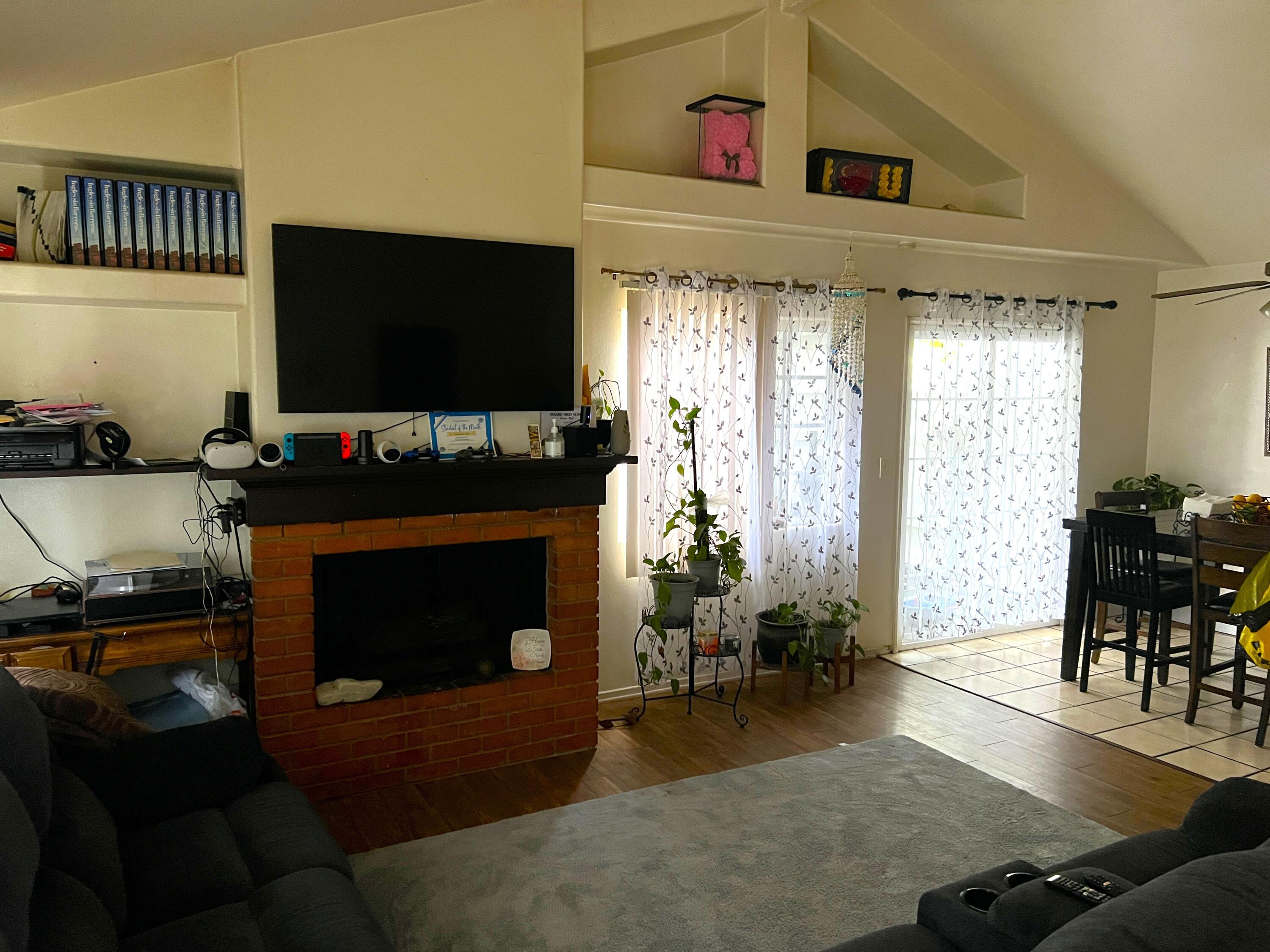 1241 West 7th Street, Unit 1 Oxnard, CA 93030 - Photo 6 of 8 a living room with furniture and a flat screen tv