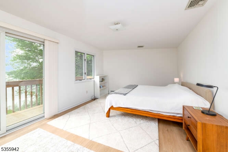 7 Capstan Road West Milford, NJ 07480 - Photo 15 of 33 a bedroom with a bed and wooden floor