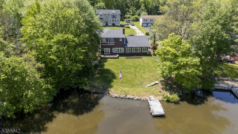7 Capstan Road West Milford, NJ 07480 - Photo 2 of 33 a view of a lake with a house in the background