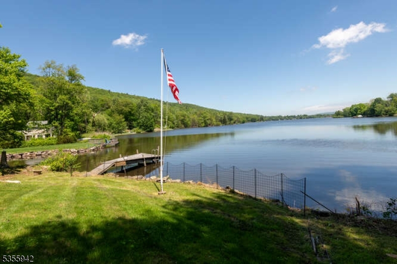 7 Capstan Road West Milford, NJ 07480 - Photo 3 of 33 a view of a lake with a garden and a table