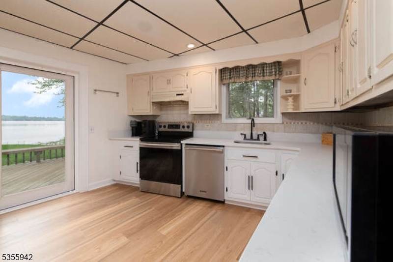 7 Capstan Road West Milford, NJ 07480 - Photo 9 of 33 a kitchen with granite countertop a sink cabinets stainless steel appliances and a window