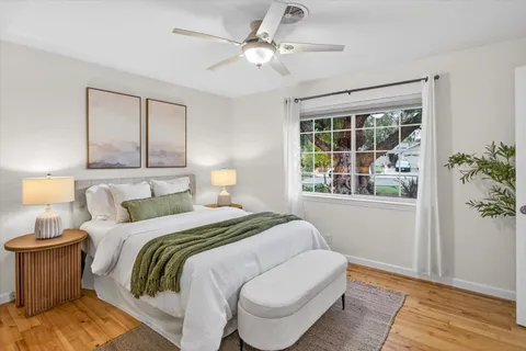 a bedroom with a large bed and a window