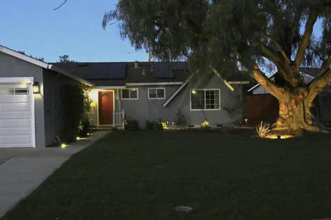 a front view of a house with a garden