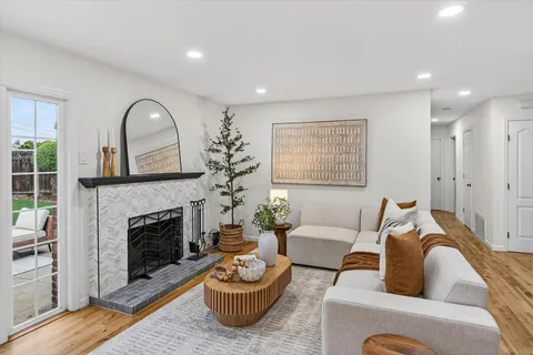 a living room with furniture a window and a fireplace