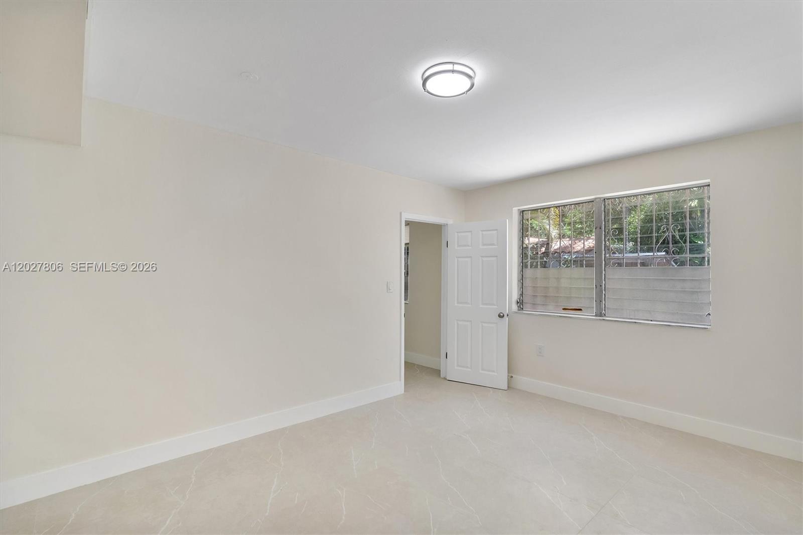 1612 Southwest 23rd Street, Unit 1612 Miami, FL 33145 - Photo 21 of 42 an empty room with windows