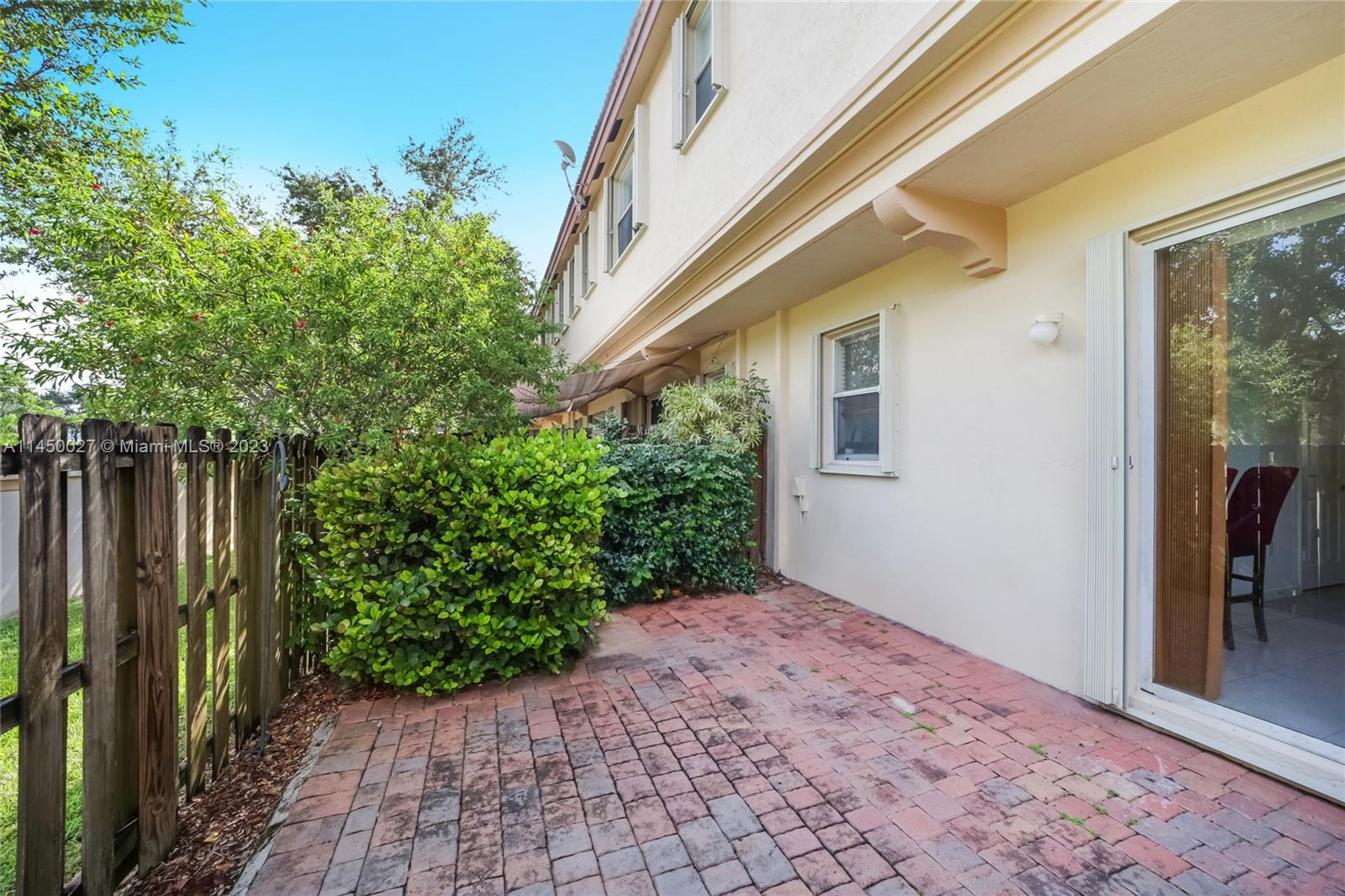 12953 Southwest 132nd Terrace Miami, FL 33186 - Photo 16 of 36 a view of backyard with potted plants and wooden fence
