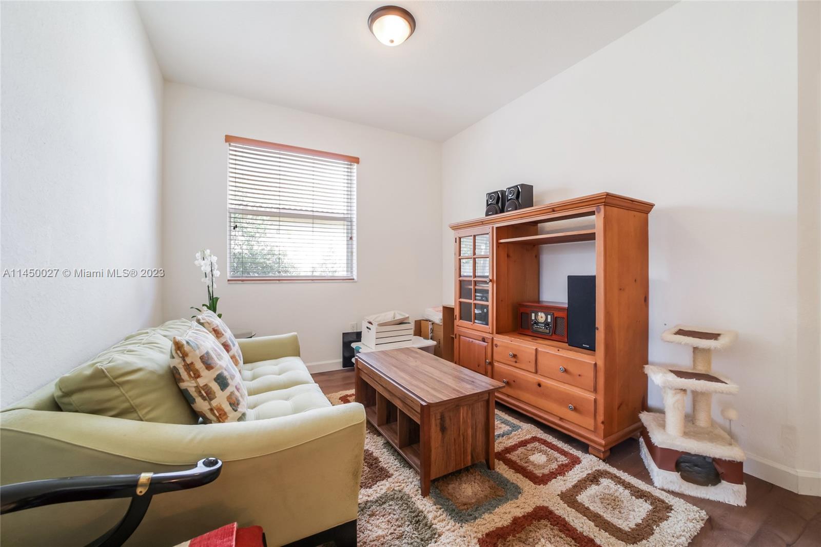 12953 Southwest 132nd Terrace Miami, FL 33186 - Photo 20 of 36 a living room with furniture and a window