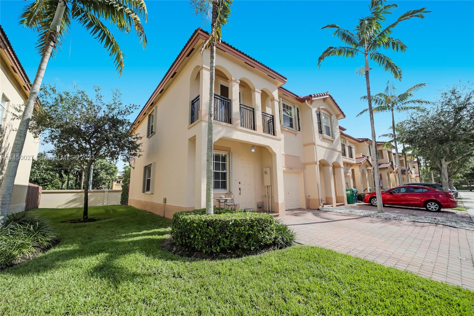 12953 Southwest 132nd Terrace Miami, FL 33186 - Photo 2 of 36 a front view of a house with garden