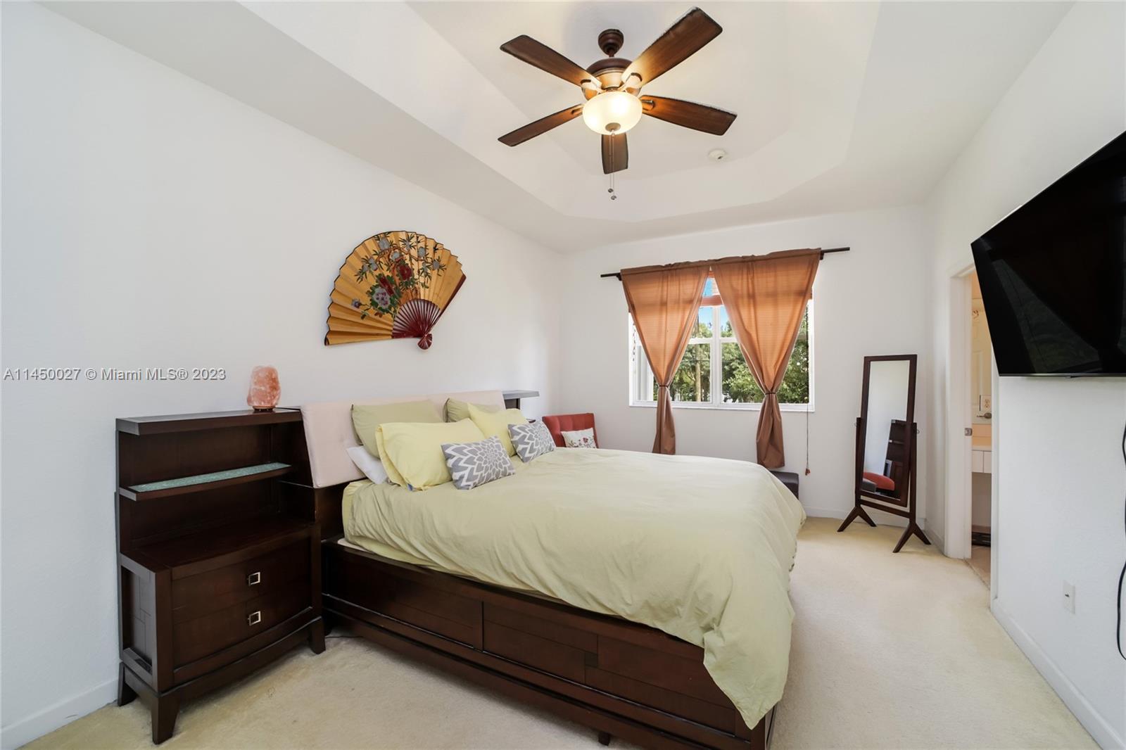 12953 Southwest 132nd Terrace Miami, FL 33186 - Photo 21 of 36 a bedroom with a bed and a flat screen tv